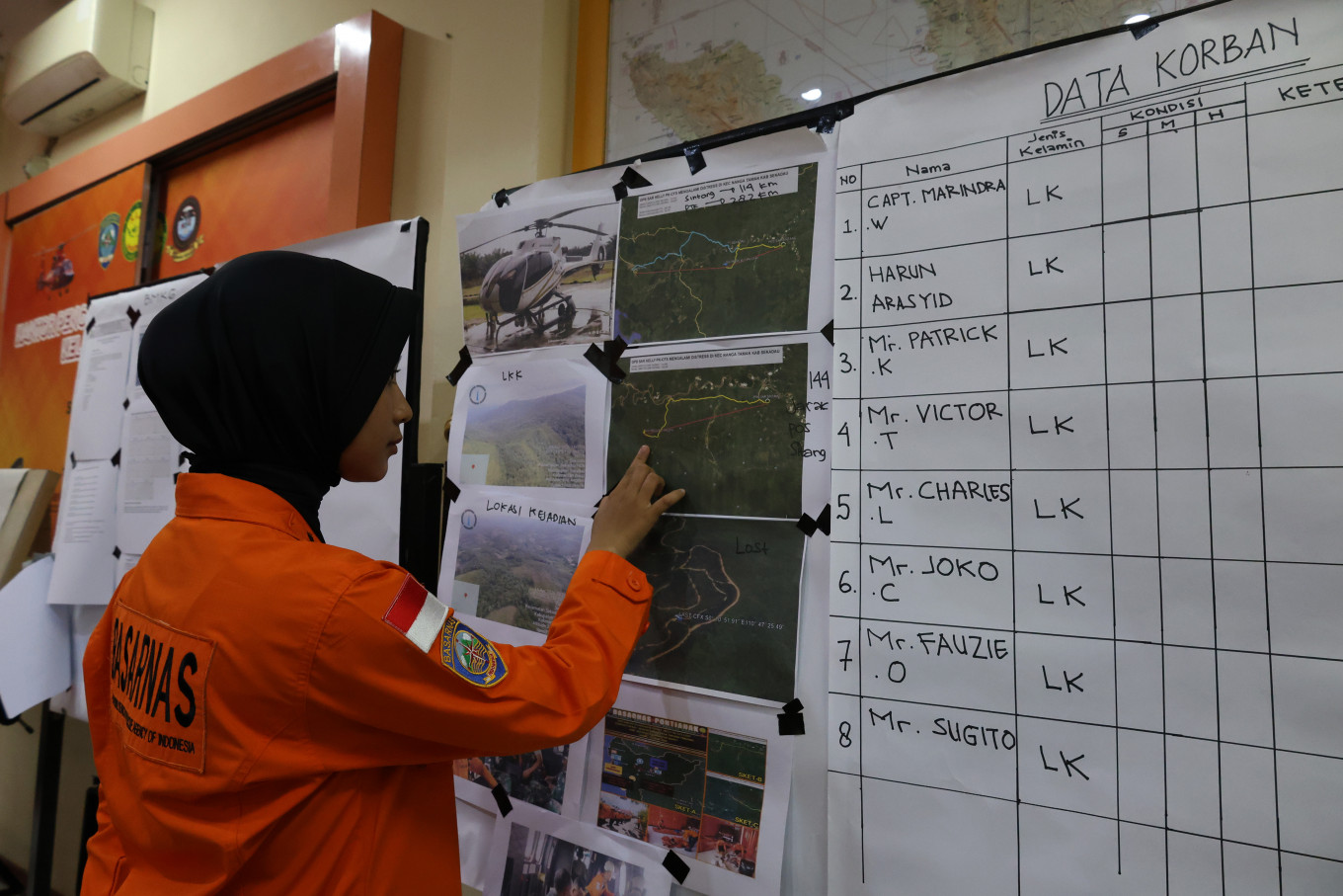 A search and rescue (SAR) team member reviews data on the Airbus Helicopter H130 crash on Thursday in Sungai Raya, Kubu Raya regency, West Kalimantan. A joint SAR team stepped up evacuation efforts after the helicopter lost contact and was later confirmed to have crashed in a forest in Nanga Taman, Sekadau regency, earlier that morning. 