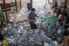 A worker sorts used plastic water bottles on April 17, 2026, at the Samici main waste bank in Cimahi, West Java. 