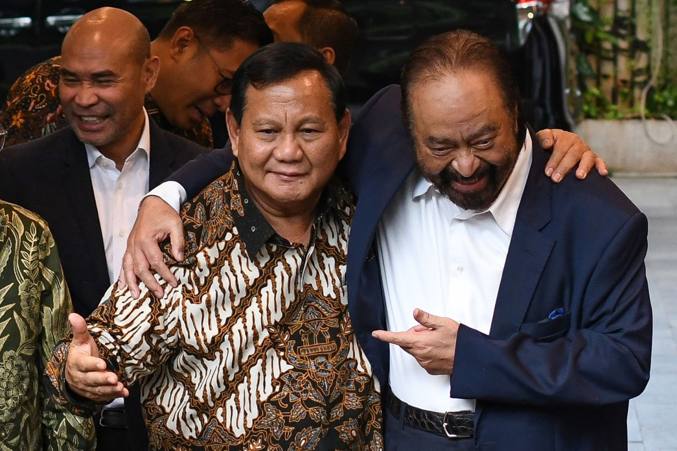 NasDem Party chair Surya Paloh (right) embraces then-president-elect and Gerindra Party chair Prabowo Subianto (left) on Tuesday after a meeting between the two party leaders at Prabowo's residence on Jl. Kertanegara in South Jakarta. Surya, who supported Prabowo's rival Anies Baswedan in the Feb. 14, 2024, election, said he would support Prabowo's administration. 