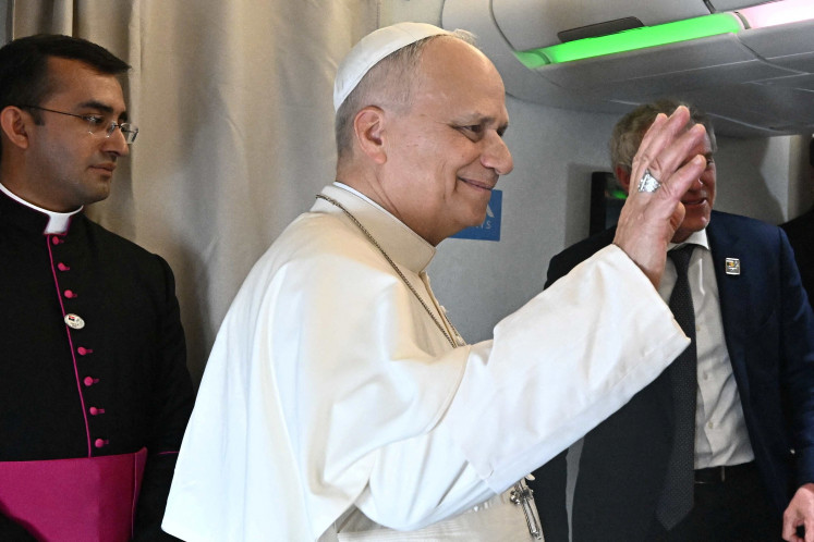 Pope Leo XIV gestures as he speaks to journalists aboard a flight on his way to Luanda, Angola, April 18, 2026. Pope Leo XIV is on an apostolic visit to Angola.
