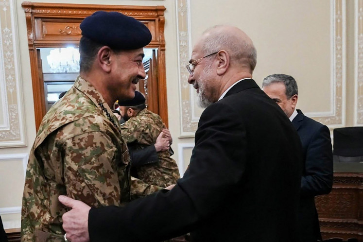 This handout photo taken and provided by the Office of Iranian Parliament Speaker on April 16, 2026, shows Iranian Parliament speaker Mohammad Bagher Ghalibaf (right) welcoming Pakistan's Army Chief Asim Munir before their meeting in Tehran.