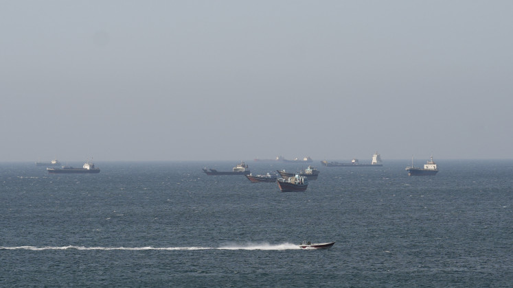 Ships and tankers in the Strait of Hormuz off the coast of Musandam, Oman, April 18, 2026. 