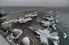 A general view shows the flight deck on board the aircraft carrier USS Theodore Roosevelt (CVN 71) as the vessel sails towards the Straits of Malacca heading to Singapore on October 23, 2015. 