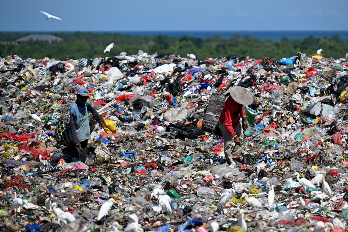 Waste pickers look for recycle, reusable and resaleable trash on April 17, 2026, at the Suwung Landfill in Denpasar, Bali.