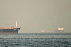 Cargo ships and tankers are seen off the coast city of Fujairah, in the Strait of Hormuz in the northern Emirate on February 25, 2026.
