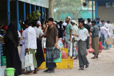 Rohingya refugees stand in queue to receive ration from the World Food Program (WFP), at a refugee camp in Cox's Bazar, Bangladesh, April 18, 2026