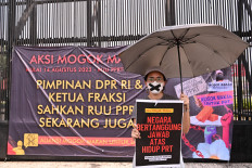 An activist takes part in a hunger strike outside the Senayan legislative complex in Jakarta on Aug. 14, 2023, as part of a protest requesting lawmakers pass the long-awaited bill to protect domestic workers.