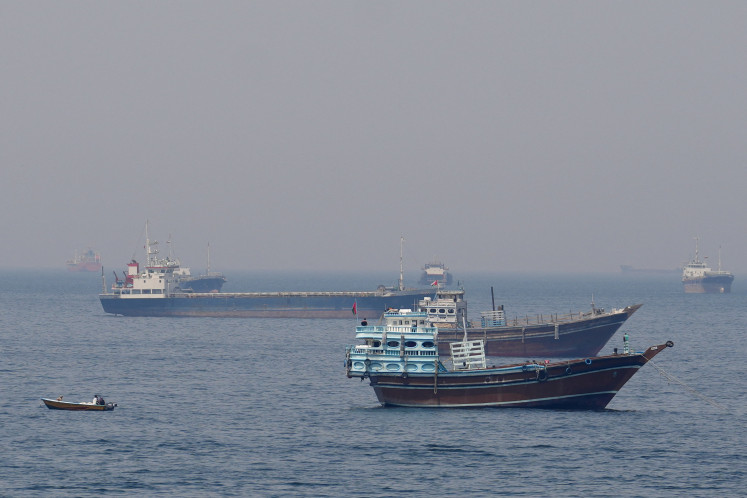 Blockade vs. blockade: Ships and boats sit on the water on Monday, April 20, 2026, in the Strait of Hormuz off the coast of Musandam, Oman. 