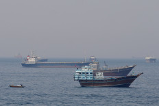 Blockade vs. blockade: Ships and boats sit on the water on Monday, April 20, 2026, in the Strait of Hormuz off the coast of Musandam, Oman. 