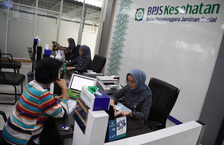 An official from the national health insurance provider BPJS Kesehatan helps a customer on May 14, 2024, at a South Jakarta office. 
