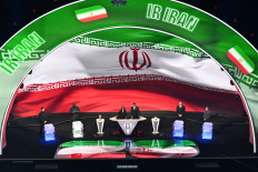 Iran's flag is displayed on a screen during the draw for the 2026 FIFA World Cup taking place in the United States, Canada and Mexico, at the Kennedy Center in Washington, DC, the US, on Dec. 5, 2025.