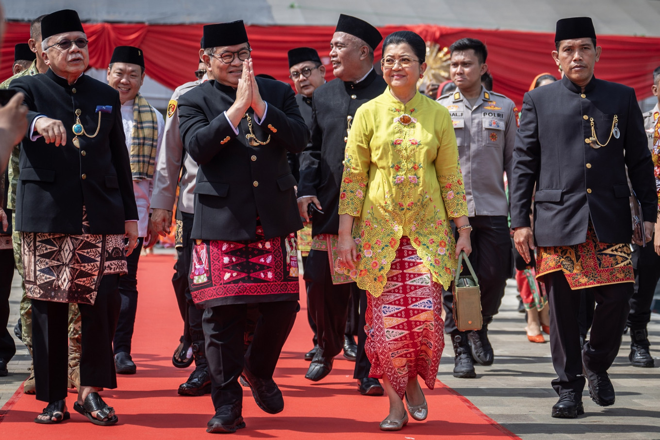 Jakarta Governor Pramono Anung (second left) walks with his wife Endang Nugrahani (third right) and former governor Fauzi Bowo (left) at the opening of the annual Lebaran Betawi event on April 11, 2026, at Lapangan Banteng park in Central Jakarta.