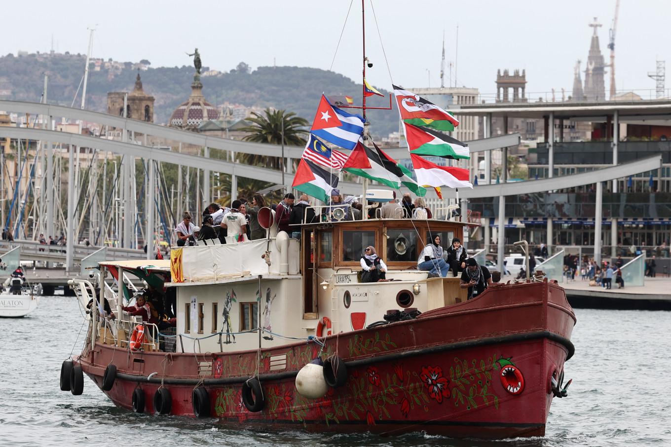 A boat makes a symbolic departure from Barcelona&rsquo;s Port Vell in Spain on April 12, 2026, as the departure of a new humanitarian flotilla bound for the Gaza Strip was postponed due to bad weather.
