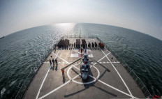 Indonesian Navy personnel stand on deck aboard hospital ship KRI dr. Soeharso on Dec. 3, 2025, during a disaster drill in the waters of Riau province near the Strait of Malacca.