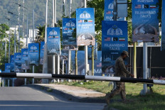 An army soldier walks past posters highlighting Pakistan's mediation of Iran-United States peace talks near the Serena Hotel at the Red Zone area in Islamabad, Pakistan on April 22, 2026. Pakistani Prime Minister Shehbaz Sharif thanked US President Donald Trump on April 22 for extending a ceasefire with Iran that had been soon set to expire and urged both sides to continue talks.