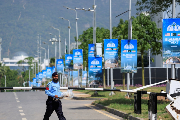 A police officer walks on the premises of the Serena Hotel as Pakistan prepares to host the United States and Iran for the second phase of peace talks in Islamabad, Pakistan, on April 21, 2026.