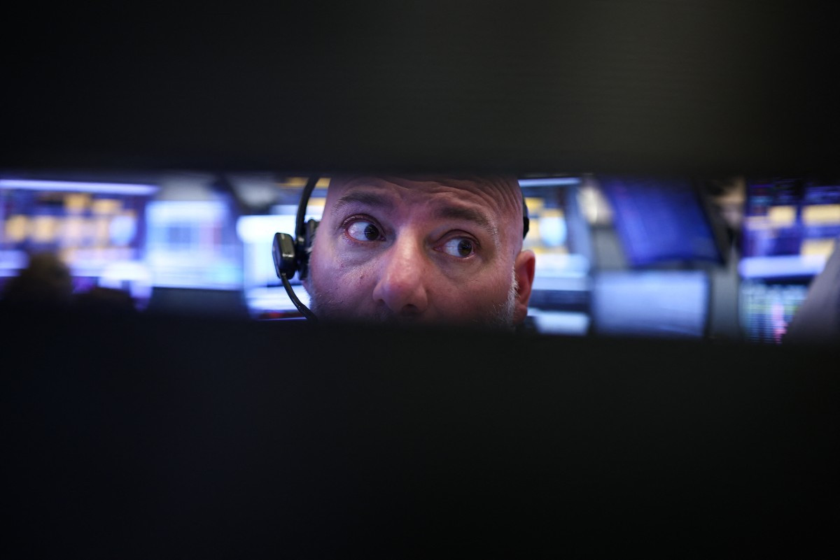 A trader works on April 24, 2026, on the floor of the New York Stock Exchange (NYSE) in New York City, the United States, before the closing bell.