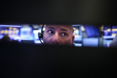 A trader works on April 24, 2026, on the floor of the New York Stock Exchange (NYSE) in New York City, the United States, before the closing bell.
