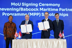 Babcock International Group chief executive officer David Lockwood (second left) and United Kingdom Ambassador to Jakarta Dominic Jermey (second right) display Memorandum of Understanding documents on April 23, flanked by Indonesian Maritime Affairs and Fishery Minister Sakti Wahyu Trenggono (left) and UK Aviation, Maritime and Decarbonization Minister Keir Mather in Jakarta. The MoU provides Babcock/Chevening Scholarships for 30 recipients in three years, as part of the UK-Indonesia Maritime Partnership Program which was launched during the event.