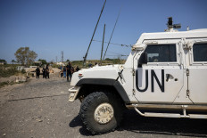 United Nations Interim Force in Lebanon (UNIFIL) peacekeepers arrive at the site of an Israeli attack that severed the last remaining bridge linking southern Lebanon to the rest of the country on April 16 in Qasmiyeh, Lebanon.
