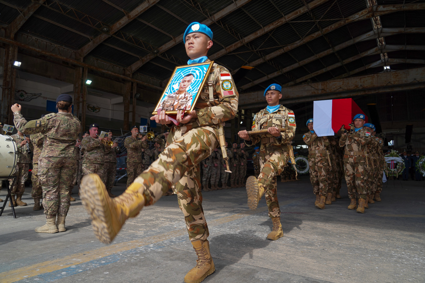 United Nations Interim Force in Lebanon (UNIFIL) personnel carry on April 26, 2026, the coffin and photograph of 31-year-old Corporal Rico Pramudia, an Indonesian national, during a ceremony at Beirut airport in Lebanon. 
