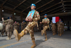 United Nations Interim Force in Lebanon (UNIFIL) personnel carry on April 26, 2026, the coffin and photograph of 31-year-old Corporal Rico Pramudia, an Indonesian national, during a ceremony at Beirut airport in Lebanon. 
