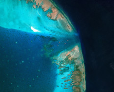 A satellite image shows fishing vessels blocked by a floating barrier at the entrance to the disputed Scarborough Shoal, in this file photo taken in the South China Sea on April 11, 2026.