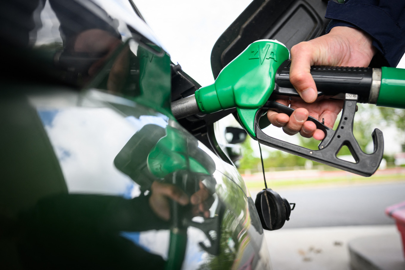A man fills in his car at a gas station in Saint-Etienne-de-Montluc, western France, on April 15, 2026, as the US-Israel war on Iran, launched on Feb. 28, has roiled global energy and equities markets, sending oil prices skyrocketing after Tehran virtually closed the key Strait of Hormuz.