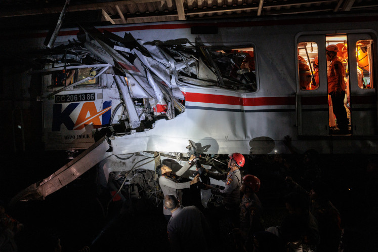 Rescuers work to save five survivors trapped inside a carriage after a passenger train locomotive pierced through the rear car of a commuter train on April 28, at Bekasi Timur station in Bekasi, West Java.