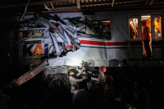 Rescuers work to save five survivors trapped inside a carriage after a passenger train locomotive pierced through the rear car of a commuter train on April 28, at Bekasi Timur station in Bekasi, West Java.