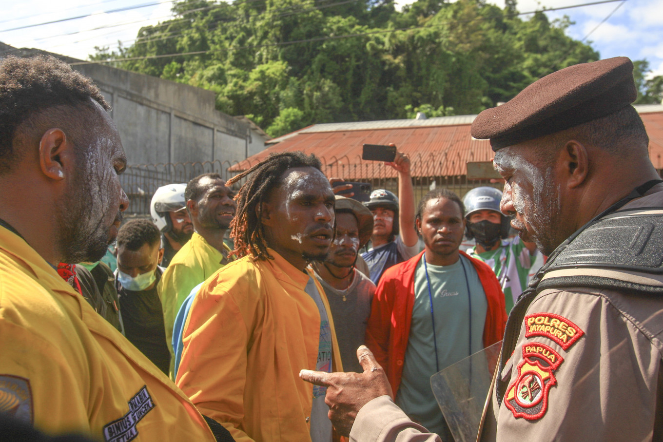 A police officer speaks with protesters opposing violence in Papua on April 27 in Jayapura, Papua. Jayapura Police deployed 1,200 joint personnel from the police and military to secure the protest. 