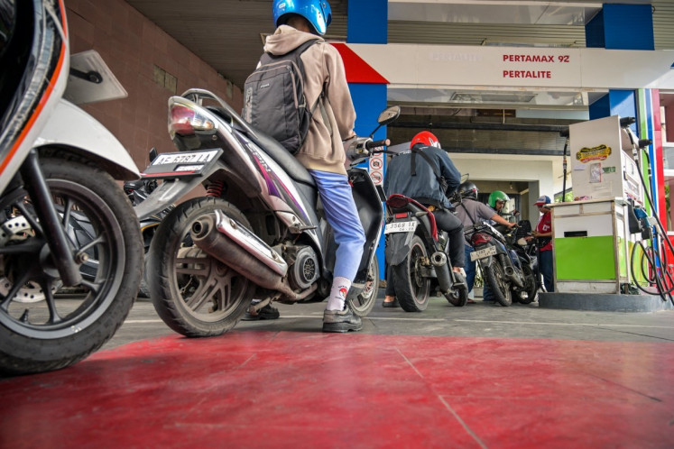 Motorists queue at a petrol station in Surabaya, East Java on March 9, 2026. 