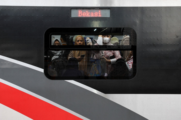 Passengers ride a commuter train during afternoon rush hour in Jakarta on April 29, 2026. 