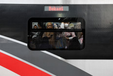 Passengers ride a commuter train during afternoon rush hour in Jakarta on April 29, 2026. 