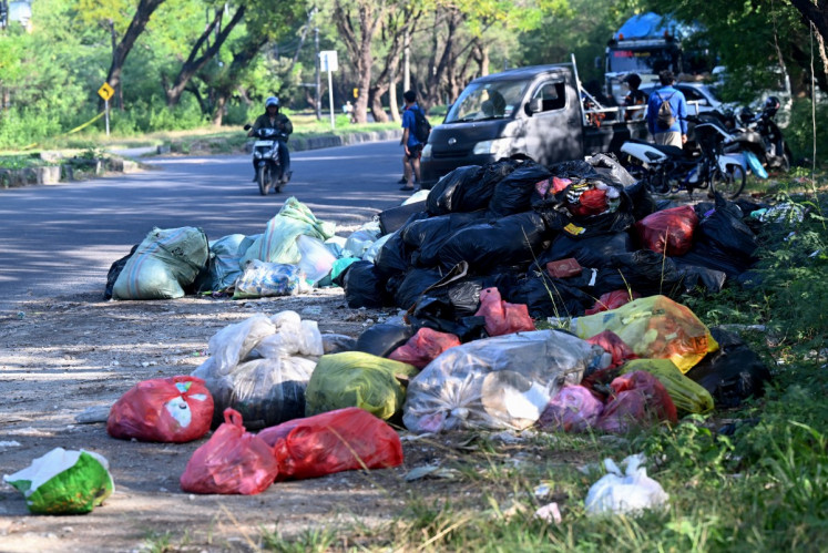 Rubbish piles up on a street in Denpasar on Indonesia's resort island of Bali on April 24, 2026. Bali's largest landfill was declared off-limits for organic waste from the beginning of April, as the government moves to enforce a longstanding ban on open tips.