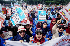 Raucous cheer: Labor union members hold banners and wave posters on May 1, 2025, during a Labor Day rally in Jakarta.