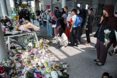 People offer flowers on May 1, 2026, and pray for the victims of a train collision that killed 16 people at Bekasi Timur Station in Bekasi, West Java.