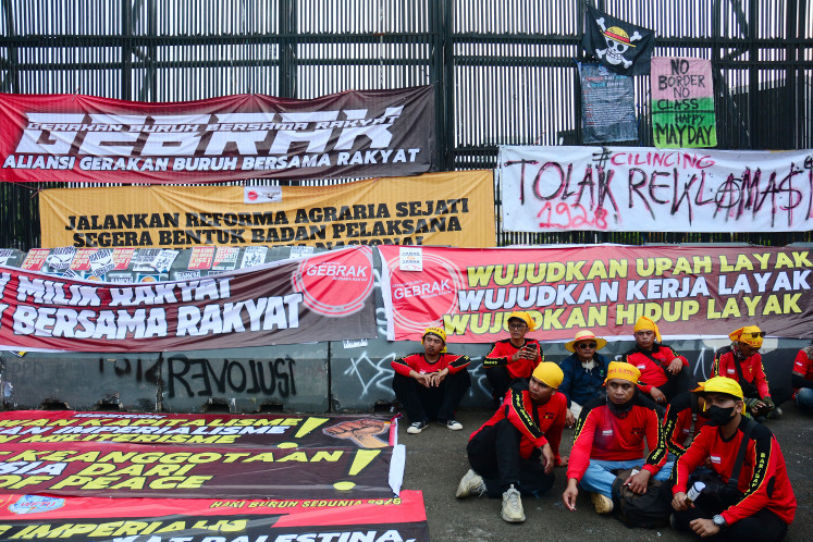 Workers stage a rally to mark May Day on Friday outside the Senayan Legislative complex in Jakarta.