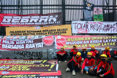 Workers stage a rally to mark May Day on Friday outside the Senayan Legislative complex in Jakarta.