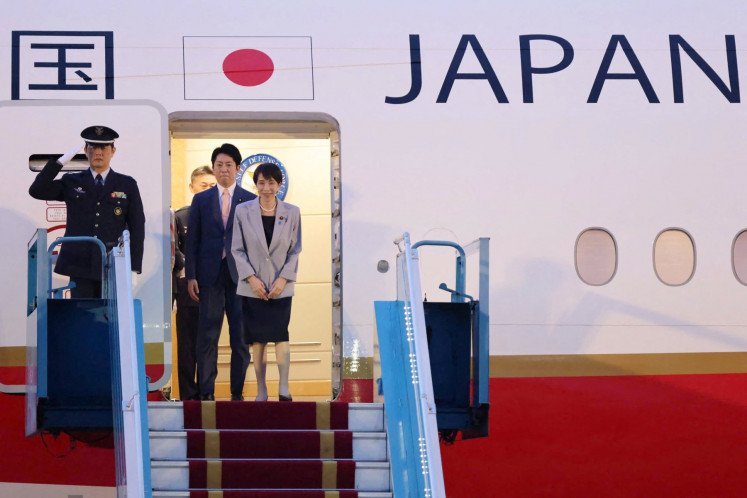 Japanese Prime Minister Sanae Takaichi (right) bows as she disembarks a plane upon her arrival at Noi Bai International Airport in Hanoi, Vietnam on May 1, 2026.