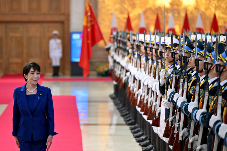 Japan&rsquo;s Prime Minister Sanae Takaichi reviews a guard of honor on May 2, 2026, during a welcoming ceremony at the Government Office in Hanoi.