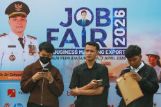 Job applicants wait for their turn to enter a job fair in Surabaya, East Java, on April 7, 2026.