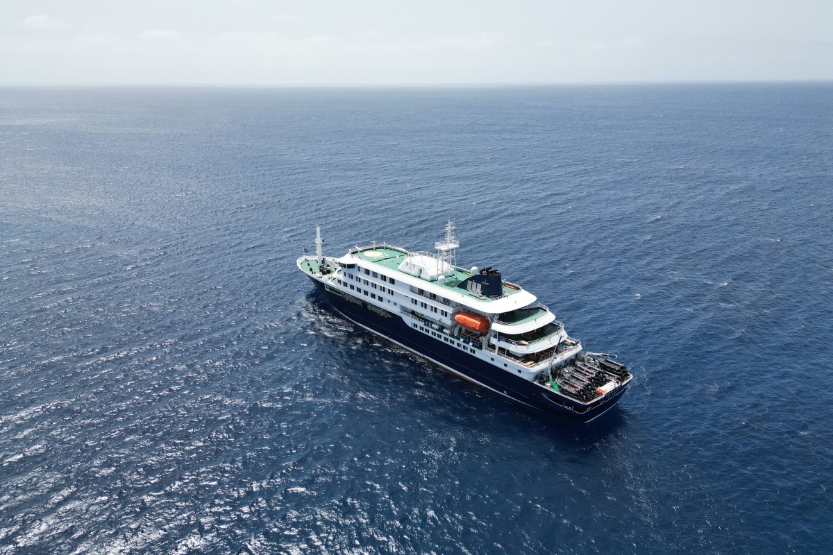 This aerial picture shows a general view of the cruise ship MV Hondius stationary off the port of Praia, the capital of Cape Verde, on May 4, 2026. 