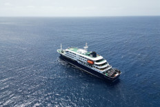 This aerial picture shows a general view of the cruise ship MV Hondius stationary off the port of Praia, the capital of Cape Verde, on May 4, 2026. 