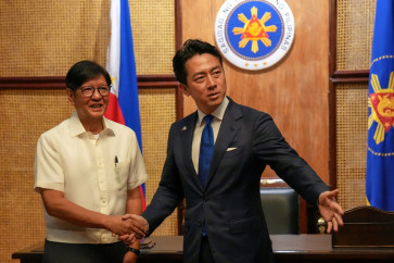Philippines President Ferdinand Marcos Jr. (left) shakes hands with Japan's Defense Minister Shinjiro Koizumi (right) at the Malacanang presidential palace in Manila on May 5, 2026. 
