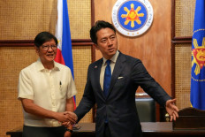 Philippines President Ferdinand Marcos Jr. (left) shakes hands with Japan's Defense Minister Shinjiro Koizumi (right) at the Malacanang presidential palace in Manila on May 5, 2026. 