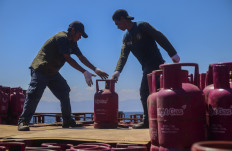 Workers unload 12-kilogram canisters of liquefied petroleum gas from Maluku capital Ambon on April 25, 2026, at Ahmad Yani Port in Ternate, North Maluku.