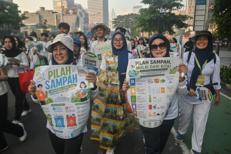 People smile as they participate in an educational rally on household waste sorting on May 3, 2026, during an Earth Day-themed Car Free Day event on Jl. Sudirman in Central Jakarta.