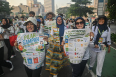 People smile as they participate in an educational rally on household waste sorting on May 3, 2026, during an Earth Day-themed Car Free Day event on Jl. Sudirman in Central Jakarta.