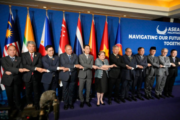 (L-R) Myanmar's Permanent Secretary of the Ministry of Foreign Affairs U Hau Khan Sum, Malaysia's Foreign Minister Mohamad Hasan, Thailand's Foreign Minister Sihasak Phuangketkeow, Timor Leste's Foreign Minister Bendito dos Santos Freitas, Vietnam's Deputy Minister of Foreign Affairs Dang Hoang Giang, Philippine's Foreign Secretary Theresa Lazaro, Singapore's Foreign Minister Vivian Balakrishnan, Brunei's Second Foreign Minister Erywan Pehin Yusof, Cambodia's Foreign Minister Prak Sokhonn, Indonesia's Foreign Minister Sugiono, Lao's Foreign Minister Thongsavanh Phomvihane, and ASEAN Secretary General Kao Kim Hourn hold hands during a group photo session at the ASEAN Foreign Ministers Meeting at the Mactan Expo in Cebu on May 7, 2026.